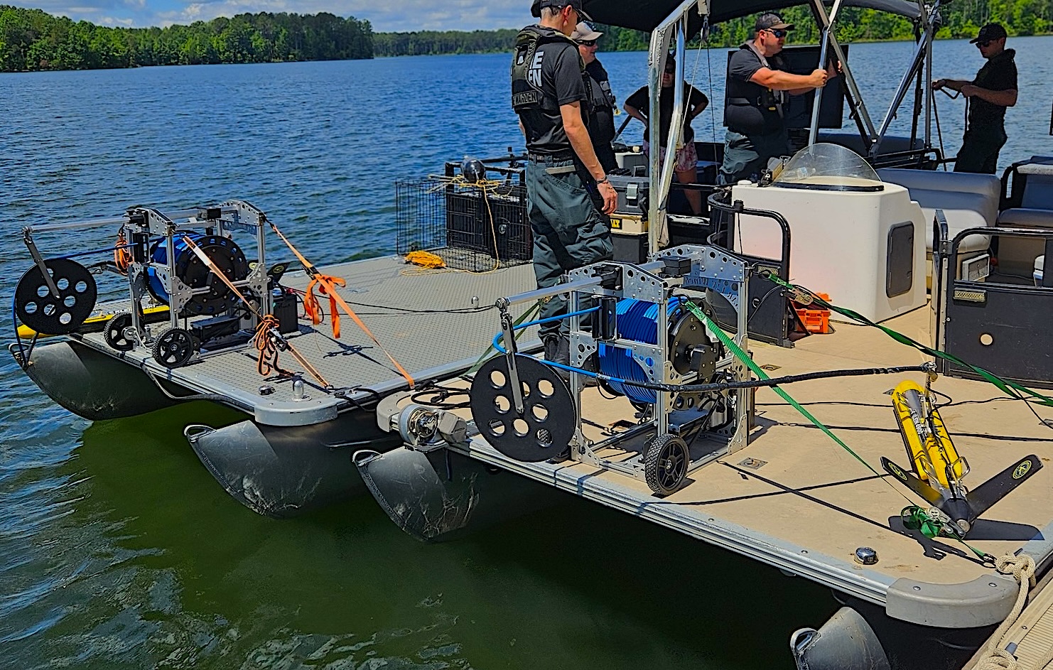 Two sonar winches deployed on a pontoon boat during a search operation.